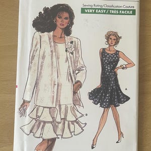 May include: A Very Easy Very Vogue sewing pattern. The pattern shows illustrations of two outfits, a dress and a suit. The pattern number is 7202, and the size range is 14-16-18. The sewing rating is Very Easy.