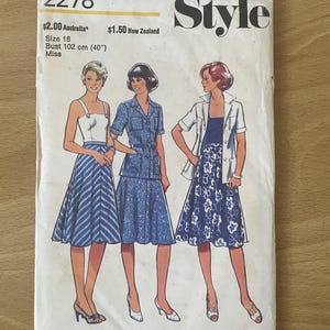 May include: A vintage sewing pattern for a dress with three different styles. The pattern is for size 18, bust 102 cm. The pattern is from Style magazine.