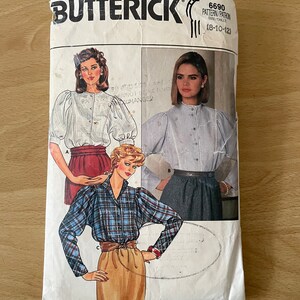 Puede incluir: Un sobre de patrón de costura vintage para una blusa de mujer. El patrón es de Butterick y es de talla 8-10-12. El sobre muestra tres estilos diferentes de blusas con mangas abullonadas.