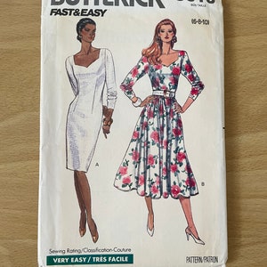 May include: A vintage sewing pattern for a dress with two different styles. The pattern is for sizes 6-8-10 and is labelled "Butterick 3613 Fast & Easy." The dress on the left is a simple white dress with a square neckline and long sleeves. The dress on the right is a floral print dress with a sweetheart neckline and long sleeves. The pattern is labelled "Very Easy/Très Facile."