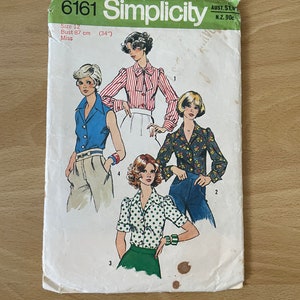 May include: Simplicity sewing pattern number 6161 for a size 12 miss, with a bust measurement of 87 cm (34 inches). The pattern includes instructions for making four different blouses with various sleeve lengths and necklines. The pattern cover features illustrations of models wearing the blouses.