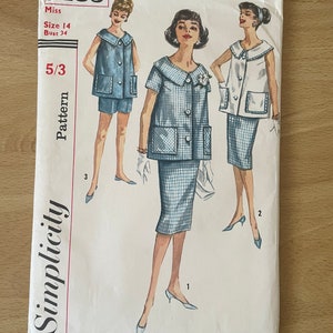 May include: Vintage Simplicity sewing pattern number 3485 for a Miss size 14, bust 34. The pattern includes three different styles of a dress with a collar and pockets. The dress is shown in a blue and white gingham pattern.