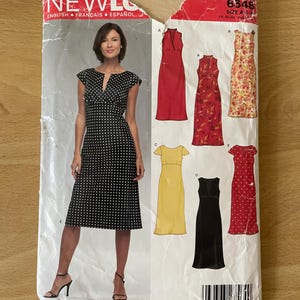 May include: Sewing pattern for five different dresses. The pattern is for sizes A-S, 6-14, 14-22. The pattern includes a black and white polka dot dress, a red dress, a yellow dress, a black dress, and a red and white polka dot dress.