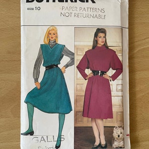 May include: A vintage sewing pattern for a dress, size 10, from Butterick, pattern number 4651. The pattern features two models wearing different versions of the dress, one in teal and one in burgundy. The text "Paper Patterns Not Returnable" is printed on the front of the package.