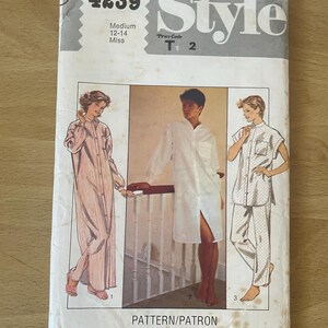 May include: A sewing pattern for a long-sleeved shirt and pants. The pattern is for sizes 12-14 and is called "Style 4239".