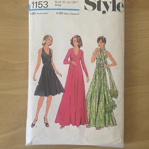 May include: Vintage sewing pattern titled "Style" featuring illustrations of three dresses. The pattern is size 14, with a bust measurement of 36 inches. The cover is white with text and illustrations in black, red, and green.