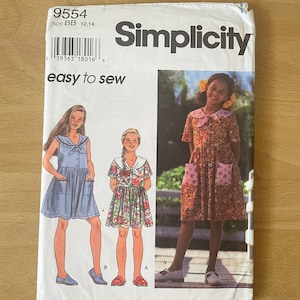 May include: Simplicity sewing pattern number 9554, size BB 12,14, easy to sew, featuring three girls wearing different dresses. The first girl is wearing a blue denim dress with a white collar and a bow. The second girl is wearing a floral print dress with a white collar and a bow. The third girl is wearing a brown dress with a white collar and a bow.