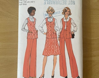 May include: A vintage Simplicity sewing pattern for a women's pantsuit. The pattern is for size 20 1/2, bust 43 inches. The pattern is from 1976 and is labeled "Look Slimmer" and "Not Returnable".