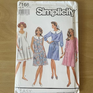 May include: Simplicity sewing pattern number 7166, size A (PT-XL), for making four different dresses. The pattern shows four women wearing the dresses in different colors and patterns. The dresses are all knee-length and have a loose, flowy fit. The pattern is labeled "EASY" and includes instructions for making the dresses.