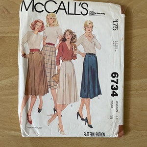 May include: McCall's sewing pattern number 6734 for a misses size 14 skirt with a 28 inch waist. The pattern shows four women wearing different styles of skirts. The pattern is from Norton Simon Inc. Company.
