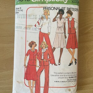 May include: Simplicity sewing pattern envelope for a Personal Fit pattern. The envelope is white with green text and features three women wearing different outfits. The pattern is available in sizes 12 and 14.