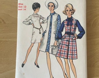 May include: Vintage Simplicity sewing pattern envelope for a dress, size 12, bust 34. The envelope features three women wearing different styles of dresses. The pattern number is 8705.