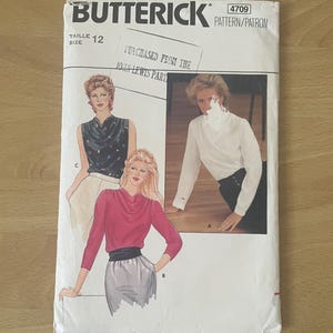 May include: A vintage Butterick sewing pattern, size 12, with illustrations of women's blouses. The envelope is white with black text and a stamp that reads "Purchased from the John Lewis Part".