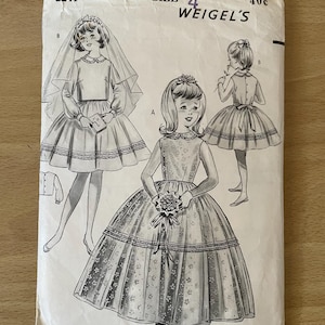 May include: Vintage sewing pattern for a girl's dress. The pattern is for size 4 and is from the brand Weigel's. The pattern shows a girl wearing a white dress with a lace trim and a veil.