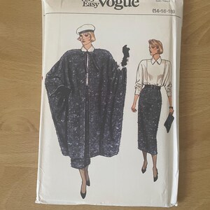 May include: A Very Easy Vogue sewing pattern packet with illustrations of a woman in a cape and skirt suit. The packet is white with black text and illustrations. The size range is (14-16-18).