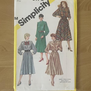 May include: A vintage Simplicity sewing pattern, size 12 Miss, featuring illustrations of dresses. The pattern cover is yellow and white with the number 6170 and the Simplicity logo. The bonus includes a special chart on how to work with plaids.