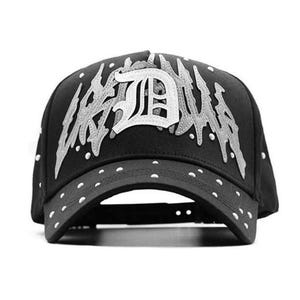 May include: Black baseball cap with white text and accents. The cap features the word "URBAN" in a stylized font, with a large "D" in the center. White dots are on the brim and around the cap.