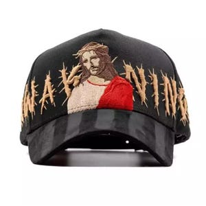May include: Black baseball cap with an embroidered image of Jesus wearing a crown of thorns and a red robe. The word "NAVIN" is embroidered in gold thread on the side of the cap.