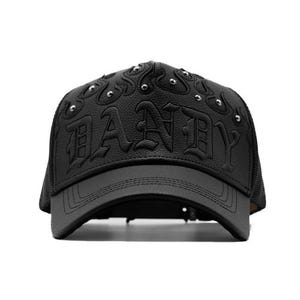 May include: Black baseball cap with the word "DANDY" embossed on the front. The cap has a curved peak, mesh back, and silver studs. The hat is made of a leather-like material.