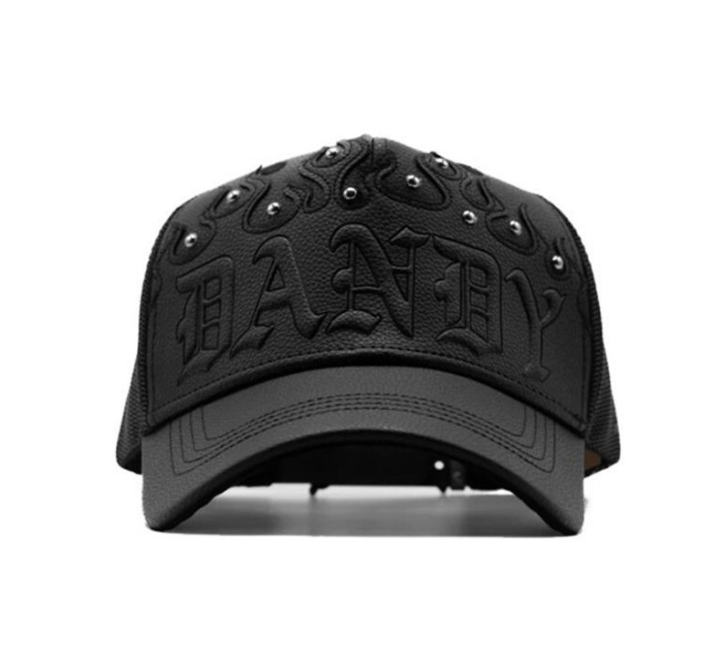 May include: Black baseball cap with the word "DANDY" embossed on the front. The cap has a curved peak, mesh back, and silver studs. The hat is made of a leather-like material.