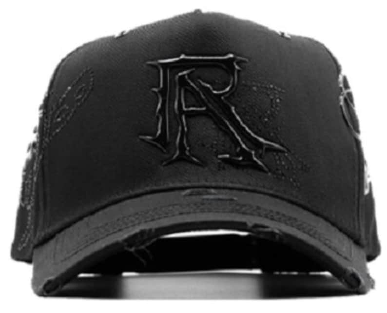 May include: Black baseball cap with a distressed brim. The cap features a large, stylized "R" on the front and decorative stitching on the sides. The overall design is dark and edgy.