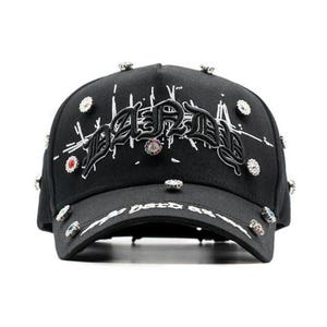 May include: Black baseball cap featuring the word "DARK" embroidered in a gothic style. The cap is adorned with decorative jewels and the text "dark as" on the brim.