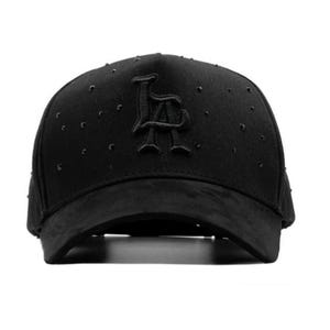 May include: Black baseball cap featuring the letters "LA". The cap has a curved peak and small, decorative studs. The hat is made of a suede-like material. The cap is a stylish accessory.