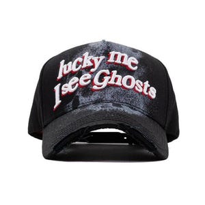 May include: Black baseball cap with a distressed finish. The cap displays the embroidered text "lucky me I see Ghosts" in white and red. It has a curved peak and an adjustable strap at the back.