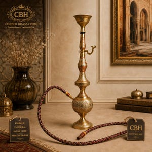 May include: A tall, ornate brass hookah featuring intricate hand-engraved floral and geometric patterns across its spherical base and slender stem. It includes a long, flexible hose with a dark red and black woven pattern and a wooden mouthpiece.