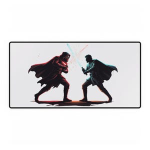 May include: A rectangular desk mat featuring a graphic illustration of two figures in capes dueling with glowing light sabers. One figure holds a red light saber, while the other holds a blue light saber. The design is set against a plain white background.
