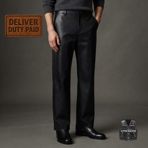 May include: Black trousers featuring a textured crocodile skin pattern, a straight-leg cut, and a standard waistband with belt loops. The trousers are paired with a dark grey jumper and black leather shoes, showcasing a consistent embossed finish.