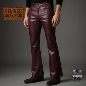 May include: Deep burgundy trousers featuring a textured crocodile skin pattern. These pants have a fitted waist, a button closure, and a flared leg silhouette. The material has a glossy finish, and the design includes standard pockets.