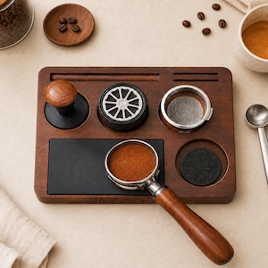 May include: A dark wood espresso station organizer featuring a wooden tamper, a metal distributor, a portafilter basket, and a portafilter with a wooden handle. The base is engraved with the text Michael's Coffee Bar and includes a black mat.
