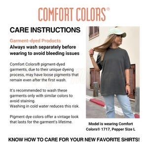 May include: A Comfort Colors t-shirt in a dark grey color, with care instructions and the Comfort Colors logo. The text on the shirt reads "Comfort Colors". The model is wearing a size L.