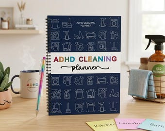 May include: A spiral-bound ADHD Cleaning Planner with a dark blue cover featuring white line-art icons of cleaning supplies. The center white band displays the text ADHD CLEANING planner in colorful letters. A rainbow-colored pen rests beside it.