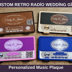 May include: Four rectangular plaques shaped like retro radios in brown, cream, purple, and blue. Each features the text "Forever Starts Today", "Emily & James", "August 08 2026", "Now Playing Can't Help Falling In Love", and a QR code.
