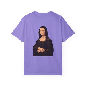 The back of a purple t-shirt shows a graphic of the Mona Lisa portrait.
