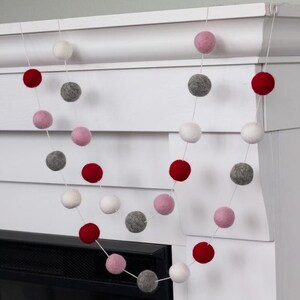 Guirnalda decorativa de San Valentín: pompones de fieltro de 2,5 cm (rojo, rosa, gris y blanco). Ideal para repisas, estantes y decoración del hogar. 100 % lana.