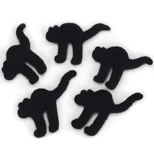 May include: Five black felt cat cutouts, each with a different pose, are arranged on a white background.