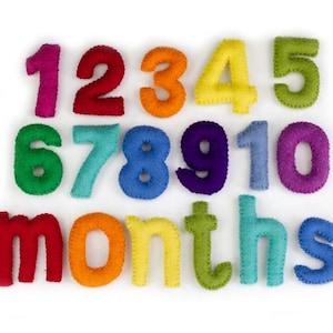 May include: Felt numbers 1 through 10 in rainbow colors, with the word "months" spelled out in felt letters.
