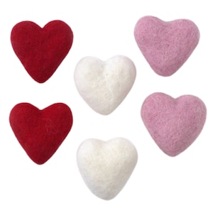 May include: Six felt hearts in three colors: red, white, and pink. The hearts are all the same size and shape.