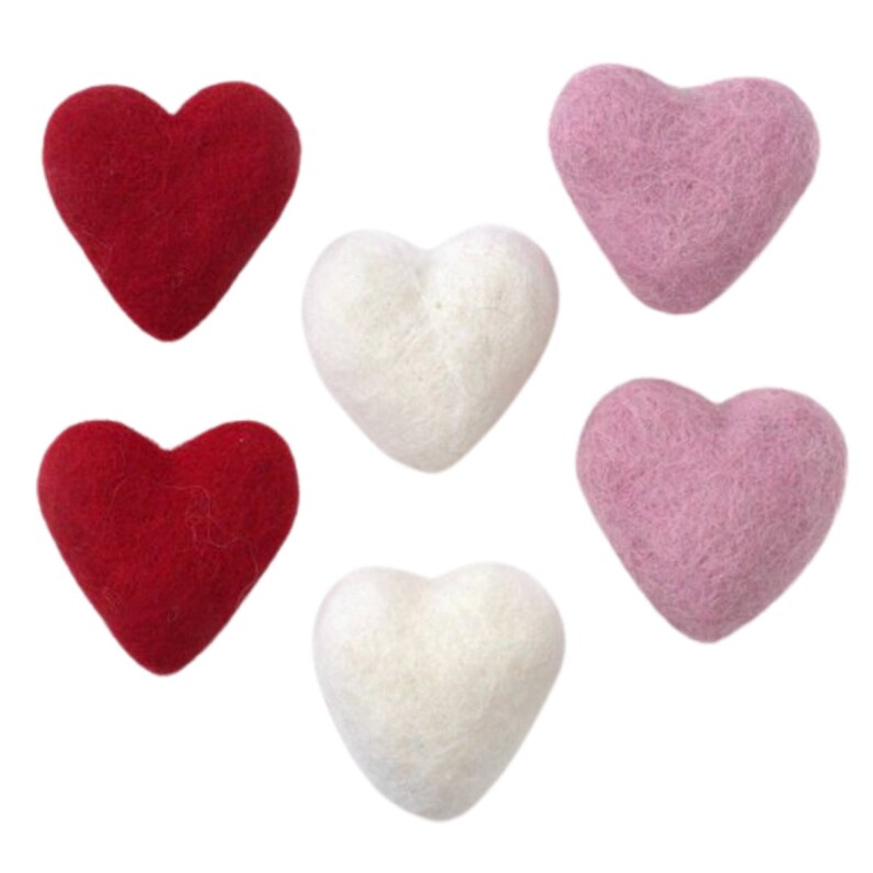 May include: Six felt hearts in three colors: red, white, and pink. The hearts are all the same size and shape.