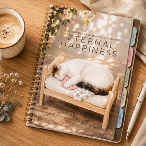 May include: A spiral-bound notebook titled 2026 CONVENTION OF JEHOVAH'S WITNESSES ETERNAL HAPPINESS, featuring a cover image of a calico cat sleeping on a miniature wooden bed, with colorful side tabs labeled Friday, Saturday, Outline, Notes, and Sunday.