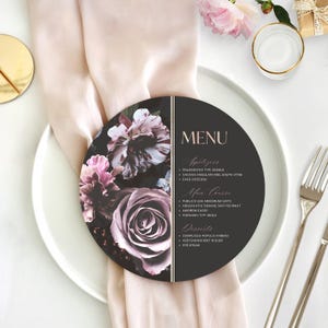 May include: A round menu card featuring a dark background with a floral design of pink and purple roses on the left side. The right side displays the text MENU, Appetizers, Main Course, and Desserts in a light font, separated by a vertical line.