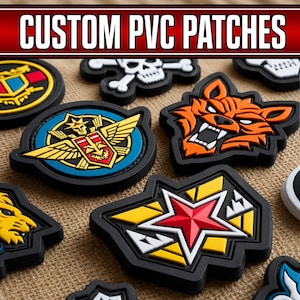 May include: A collection of custom PVC patches featuring various designs including a red star, an orange wolf head, and a winged emblem. The patches are made of moulded rubber with raised details in vibrant colours like red, yellow, blue, and orange on black bases.