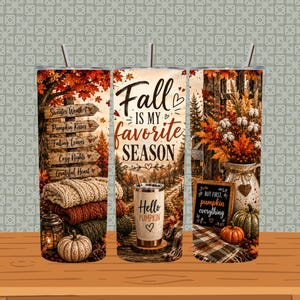 May include: A cylindrical tumbler featuring a fall-themed design with autumn leaves, a wooden signpost with text, stacked sweaters, pumpkins, a lantern, and a smaller tumbler with the text Hello Pumpkin. The centre features the text Fall is my favourite season.