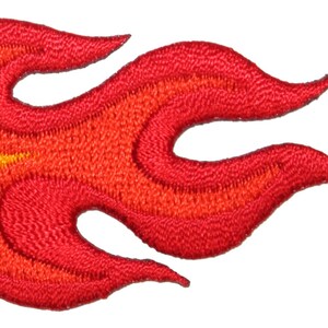 May include: Red and orange embroidered flame design patch. The flame is stylized with a pointed tip and three points on each side.