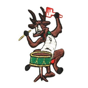 May include: An embroidered patch of a cartoon reindeer playing a drum with a drumstick. The reindeer is brown with a white shirt and green and gold drum.