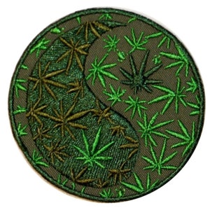 May include: Green embroidered patch featuring a yin yang symbol made of cannabis leaves. The symbol is surrounded by smaller cannabis leaves.