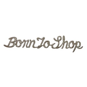 May include: Silver glitter iron-on patch with the text "Born To Shop" in a cursive font.